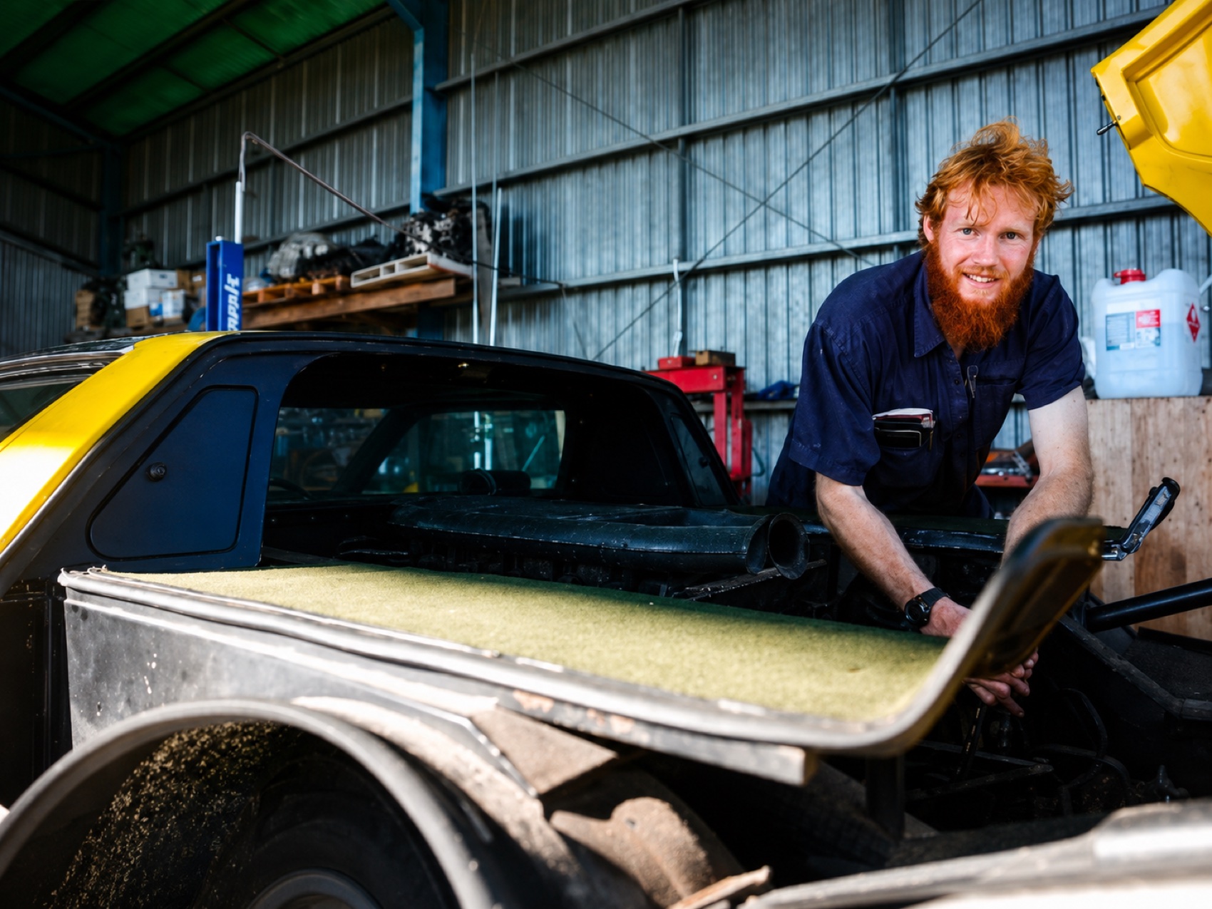 Panel beater at work on a classic body