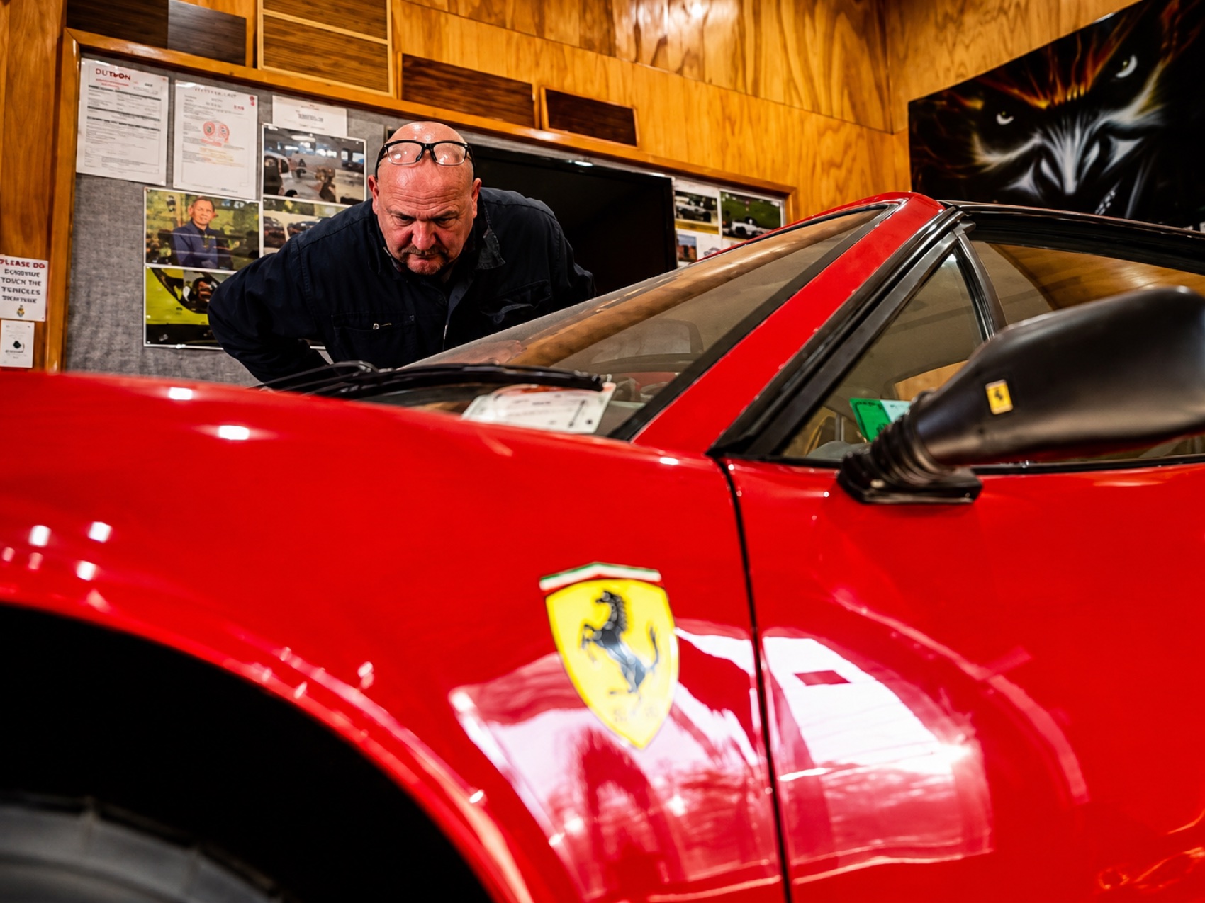 Work on a red Ferrari convertible