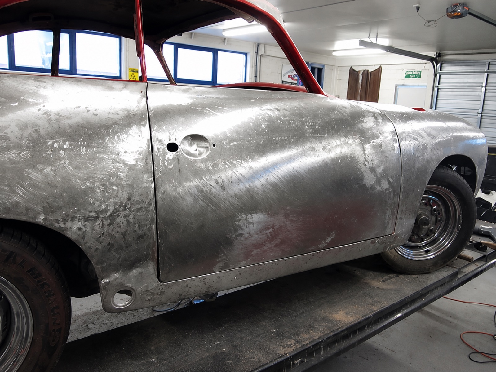 Bare metal bodywork with rust sections cut out and replaced