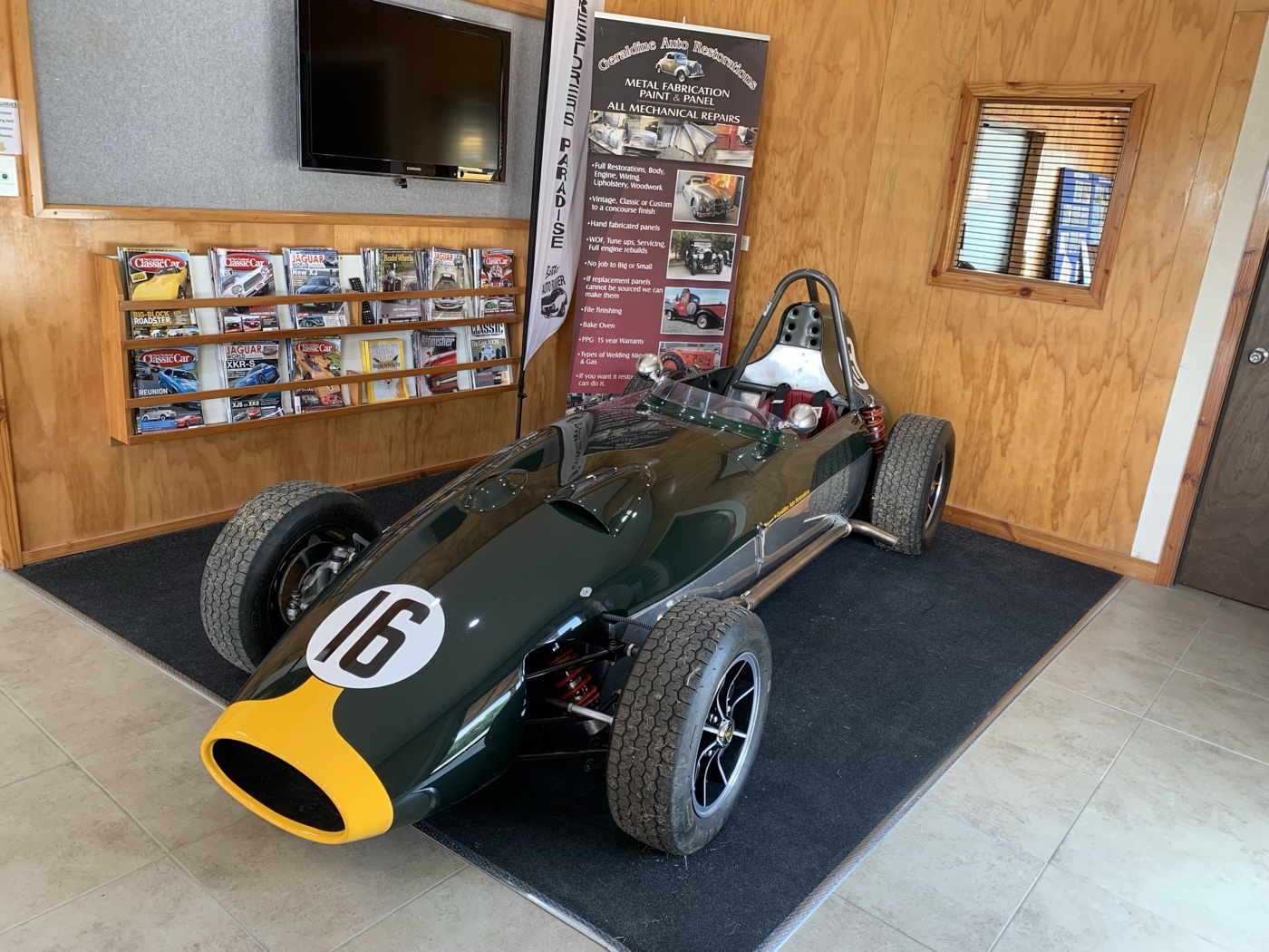 The finished green single-seater racing car on display