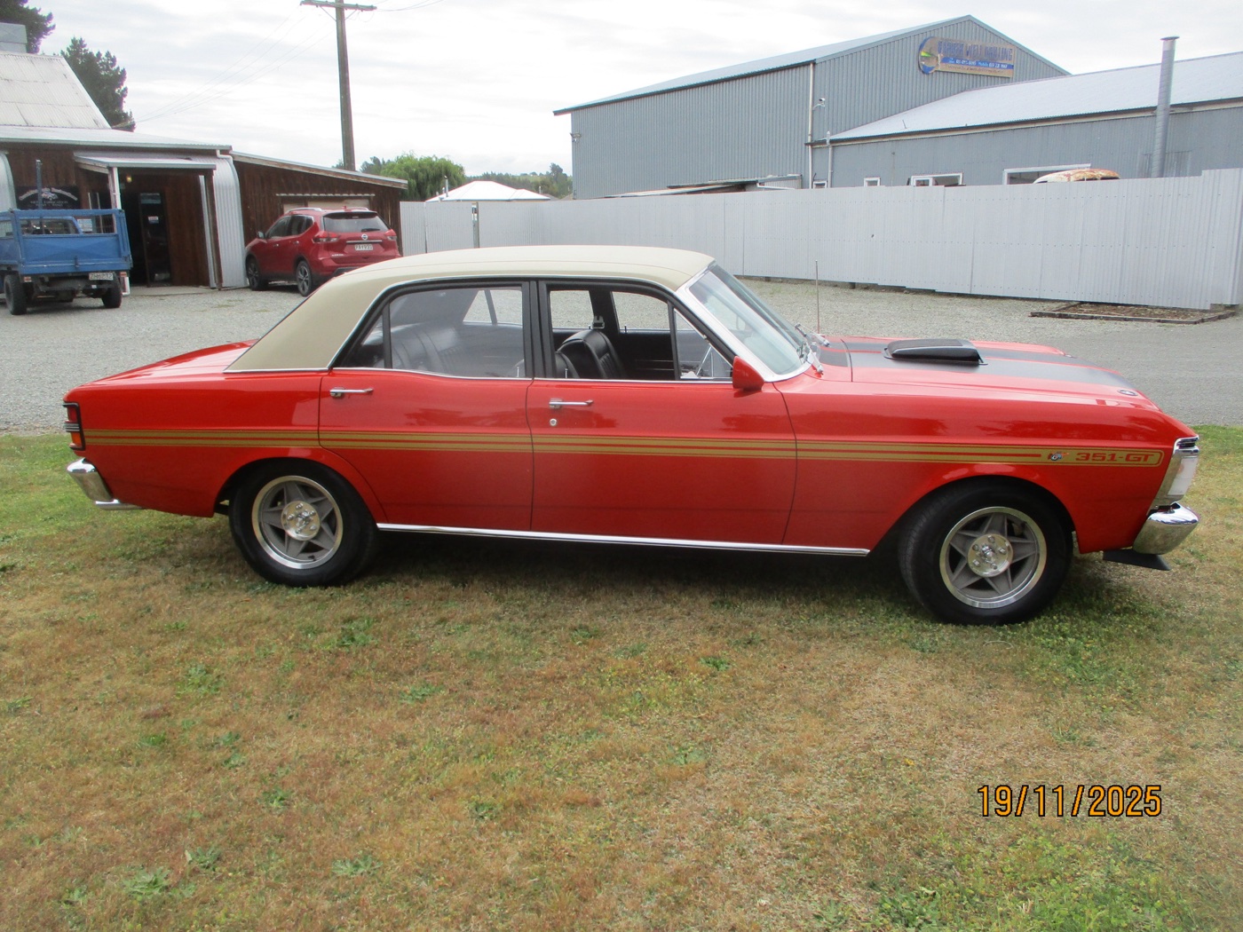 The finished red Ford Falcon with white roof and gold stripes