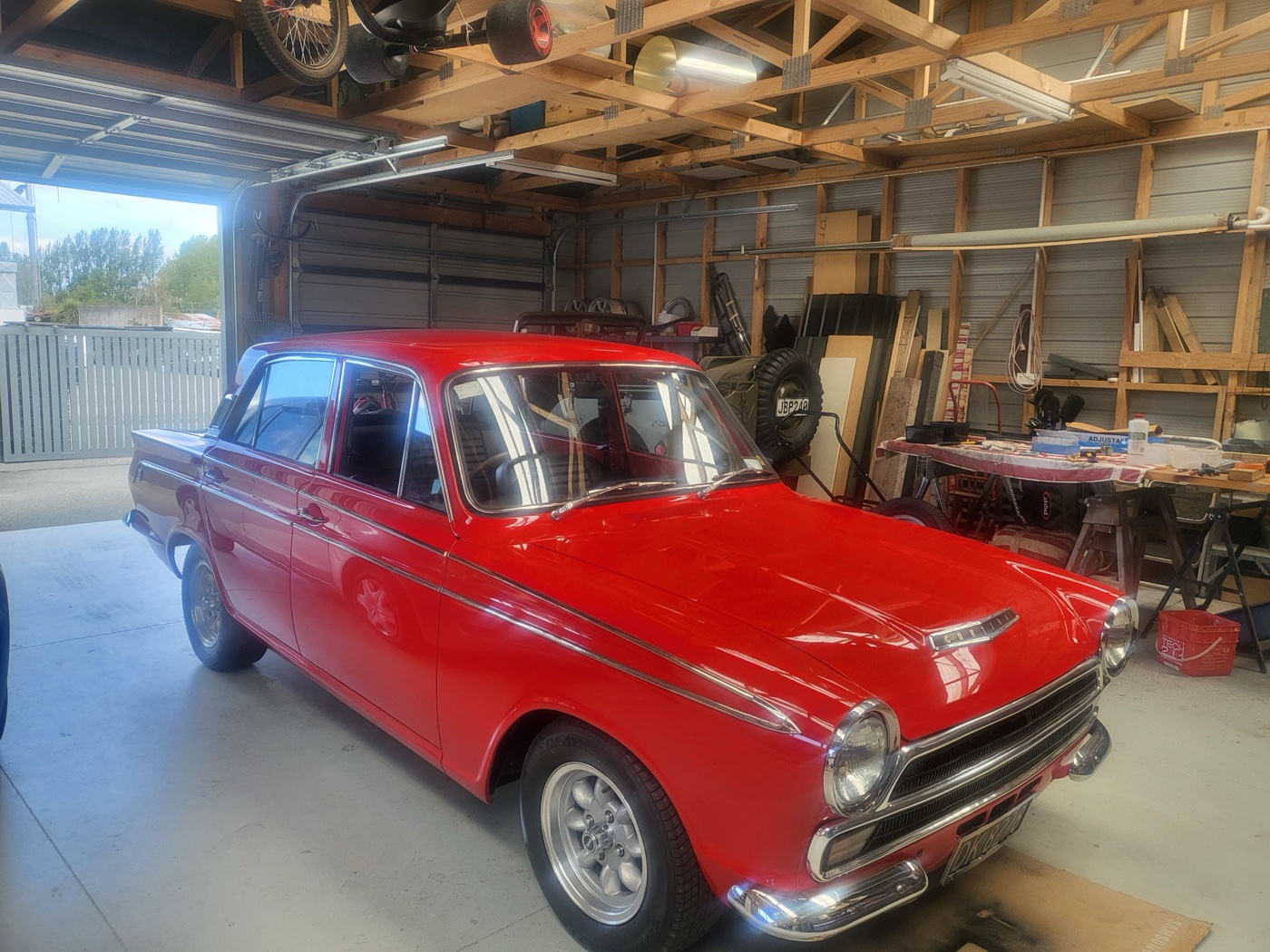 The finished red Ford Cortina in the workshop